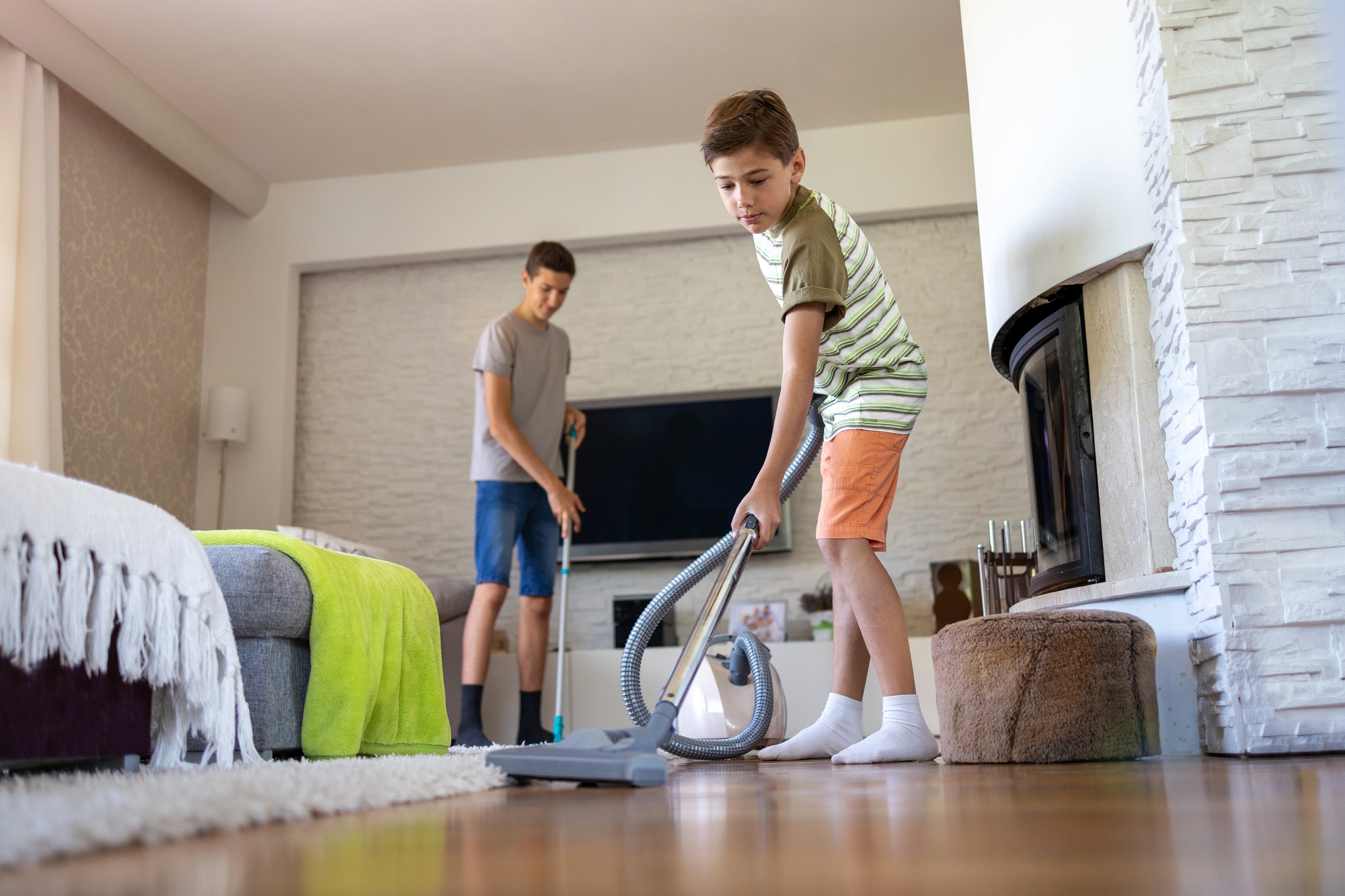 Jeff's brother is vacuuming Carpet